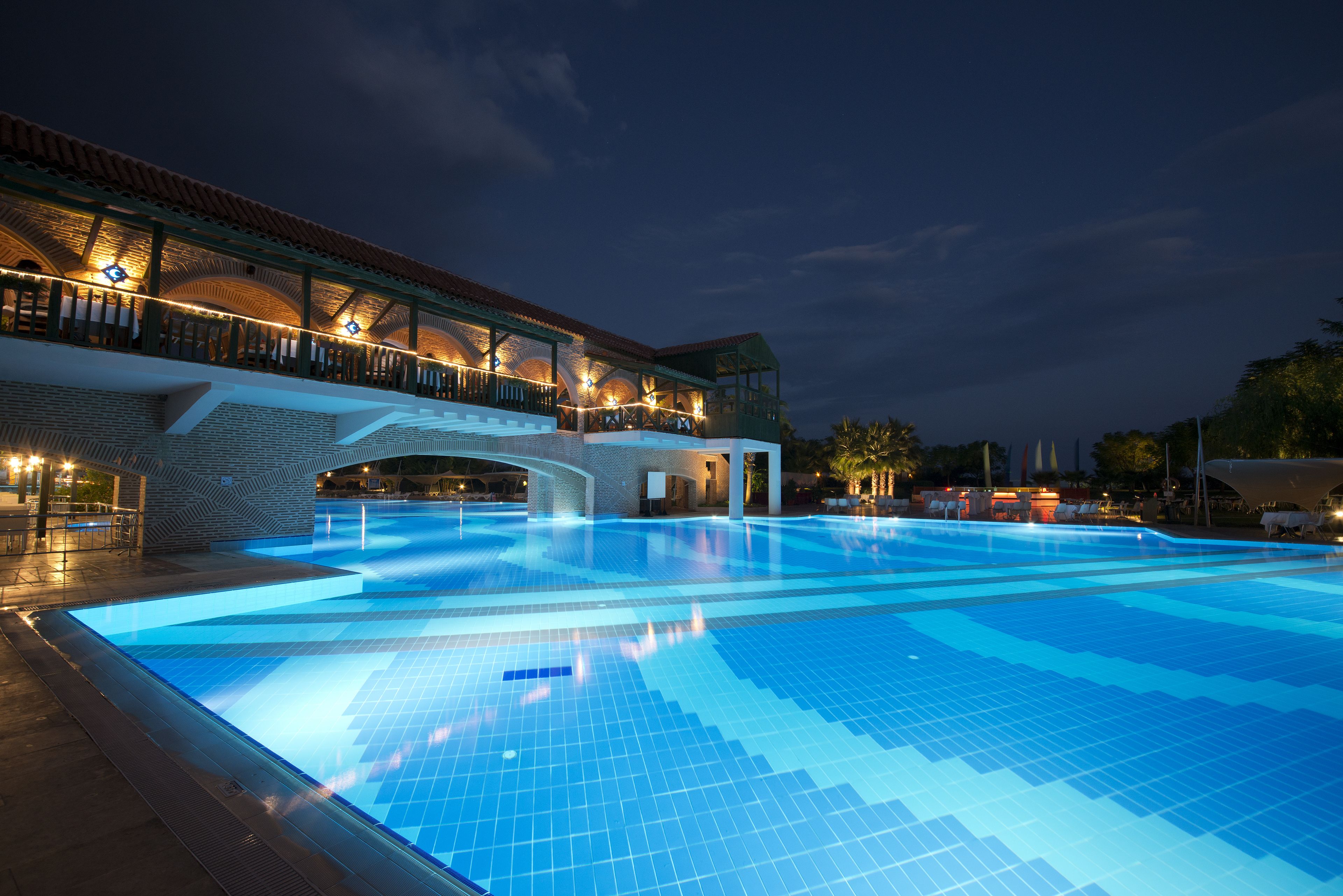 A large indoor swimming pool with a covered area and a bridge.
