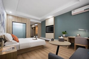 A modern hotel room with a bed, a desk, a chair, a TV, and a small table. - Kaiyue Business Hotel(Ninefang City Shop,Northmen Road ) (KUNSHAN)