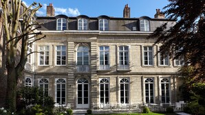 A large, historic building with multiple windows and a well-maintained garden. - Clarance Hotel Lille (Lille)