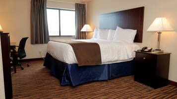 A hotel room with a large bed, two bedside lamps, a desk with a chair, and a window with curtains.