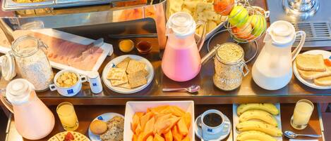 A breakfast buffet with various food items and beverages.