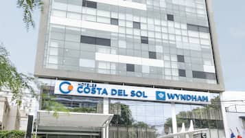 A modern hotel building with a glass facade and a sign reading "Costa del Sol Wyndham".
