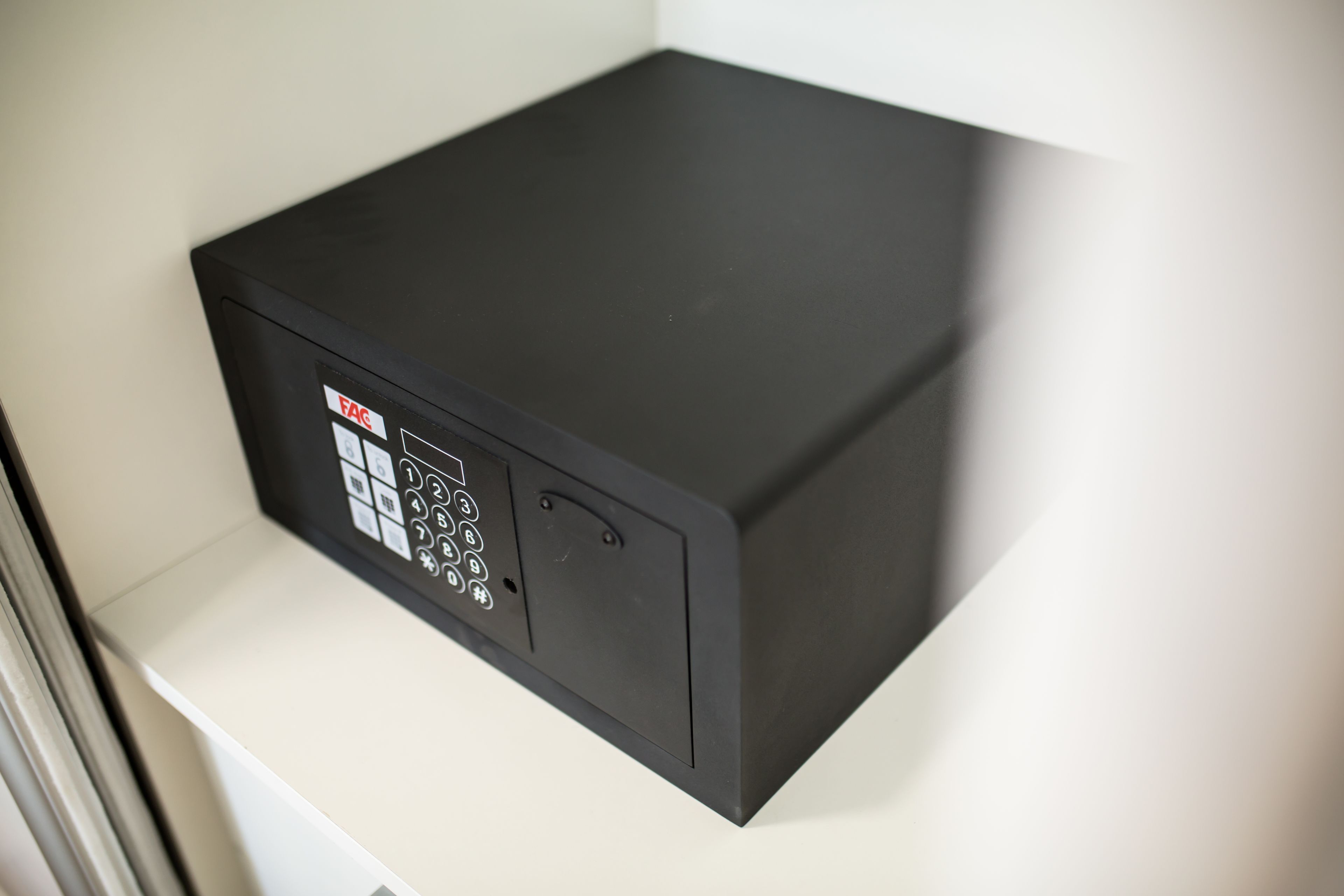 A black electronic device with a keypad and a label that reads 'FAG'.