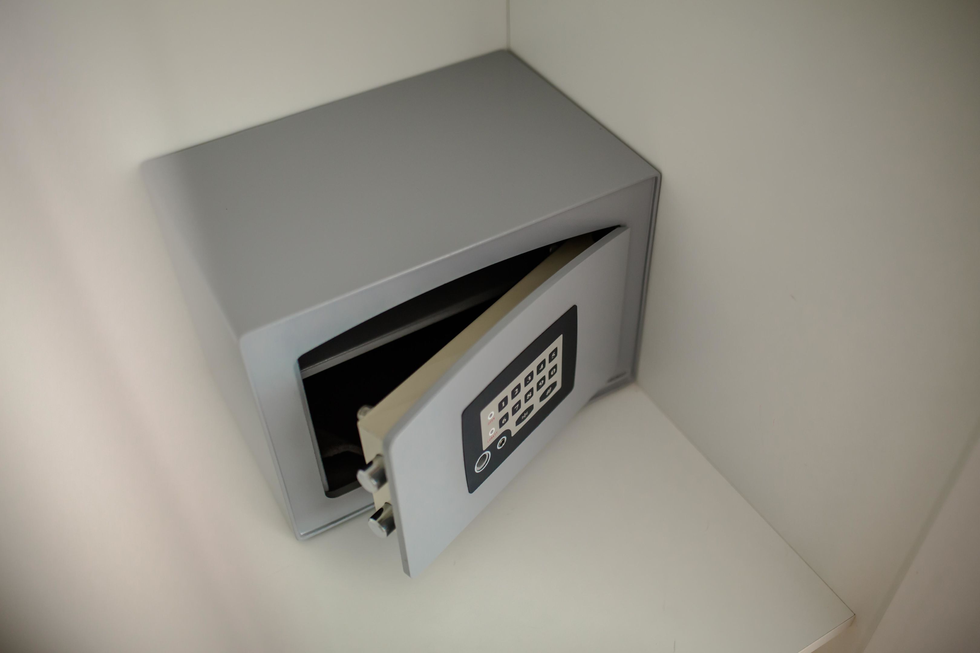 A gray, metallic safe with a keypad lock.