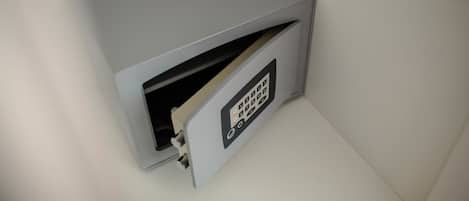 A gray, metallic safe with a keypad lock.