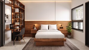 A modern bedroom with a wooden headboard, a bed, a desk with a chair, a bookshelf, and a window with a view. - Motel du Lac Beauchamp (Gatineau)