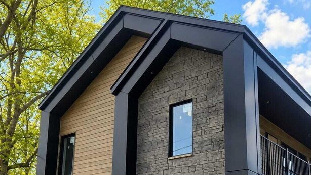 A modern two-story building with a stone facade, large windows, and a balcony. - Motel du Lac Beauchamp (Gatineau)
