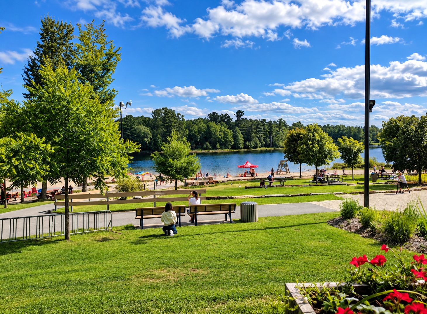 A park with a lake, benches, picnic tables, and a playground.