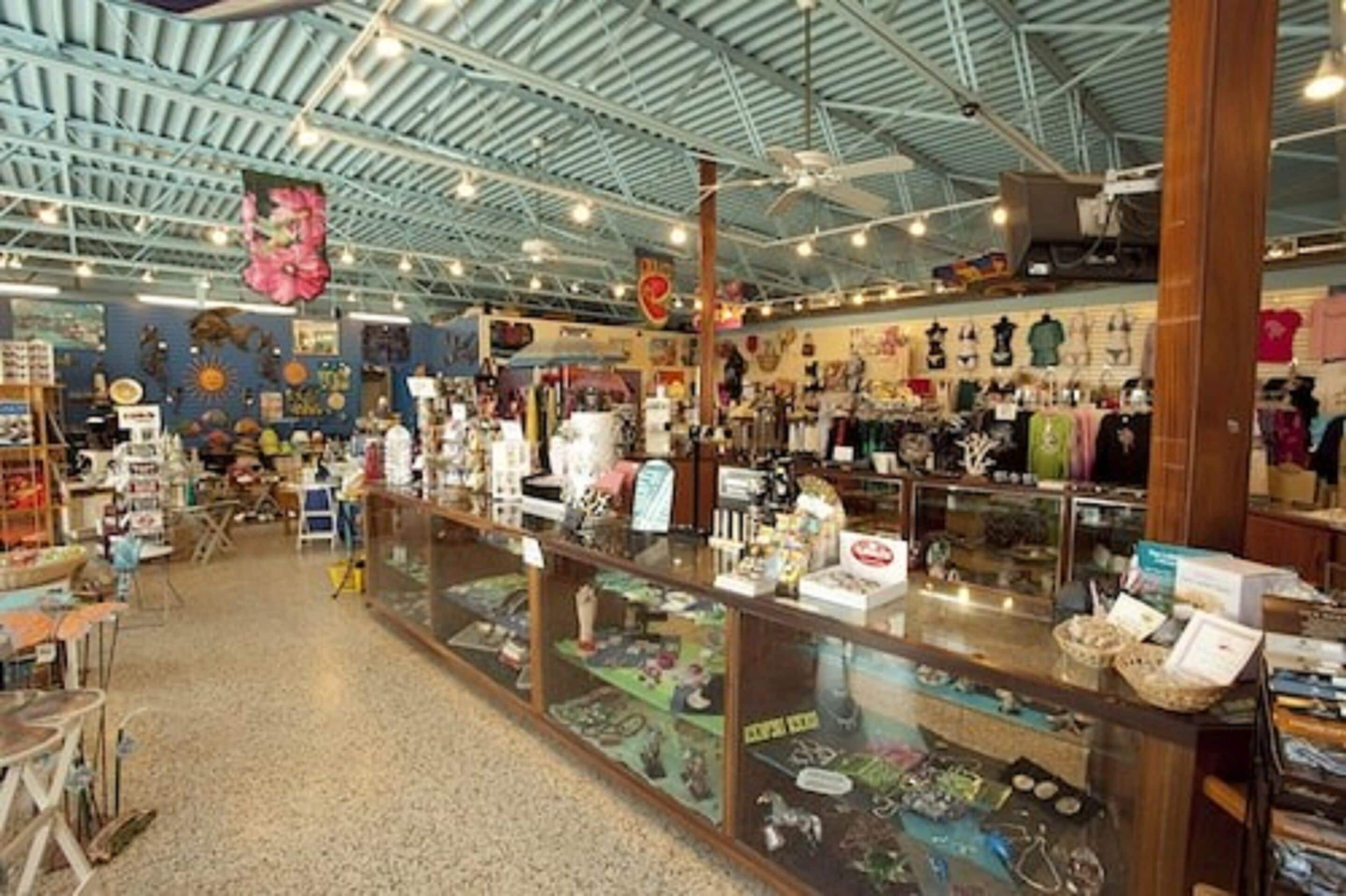 A spacious indoor market with various stalls selling goods.
