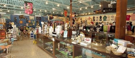 A spacious indoor market with various stalls selling goods.