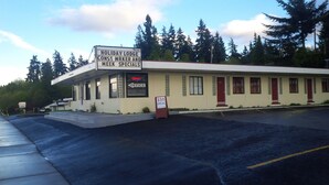 A Holiday Lodge with a sign advertising const wrker and week specials. - Holiday Lodge (Port Angeles)