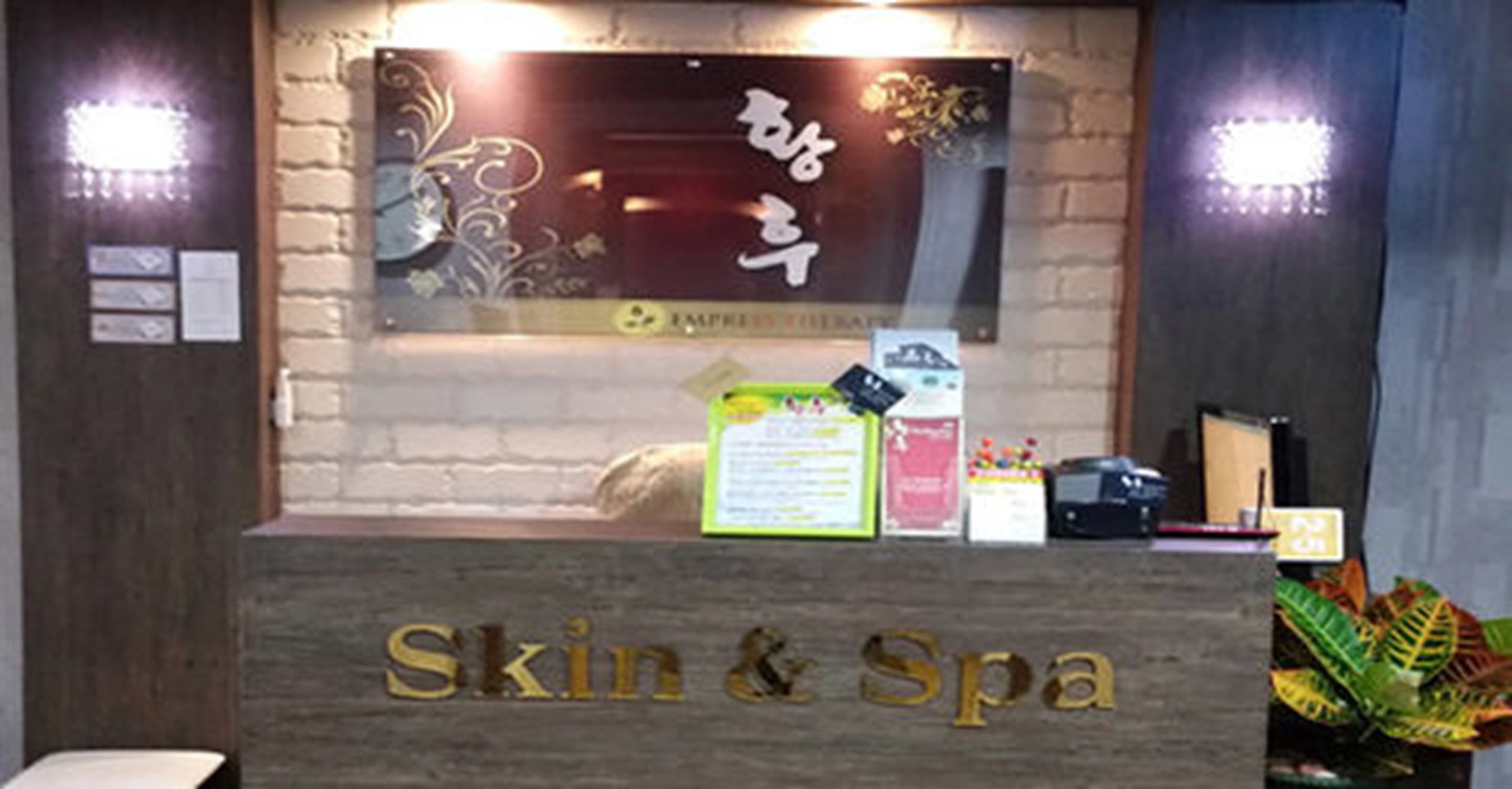 A reception desk with a sign reading "Skin & Spa".