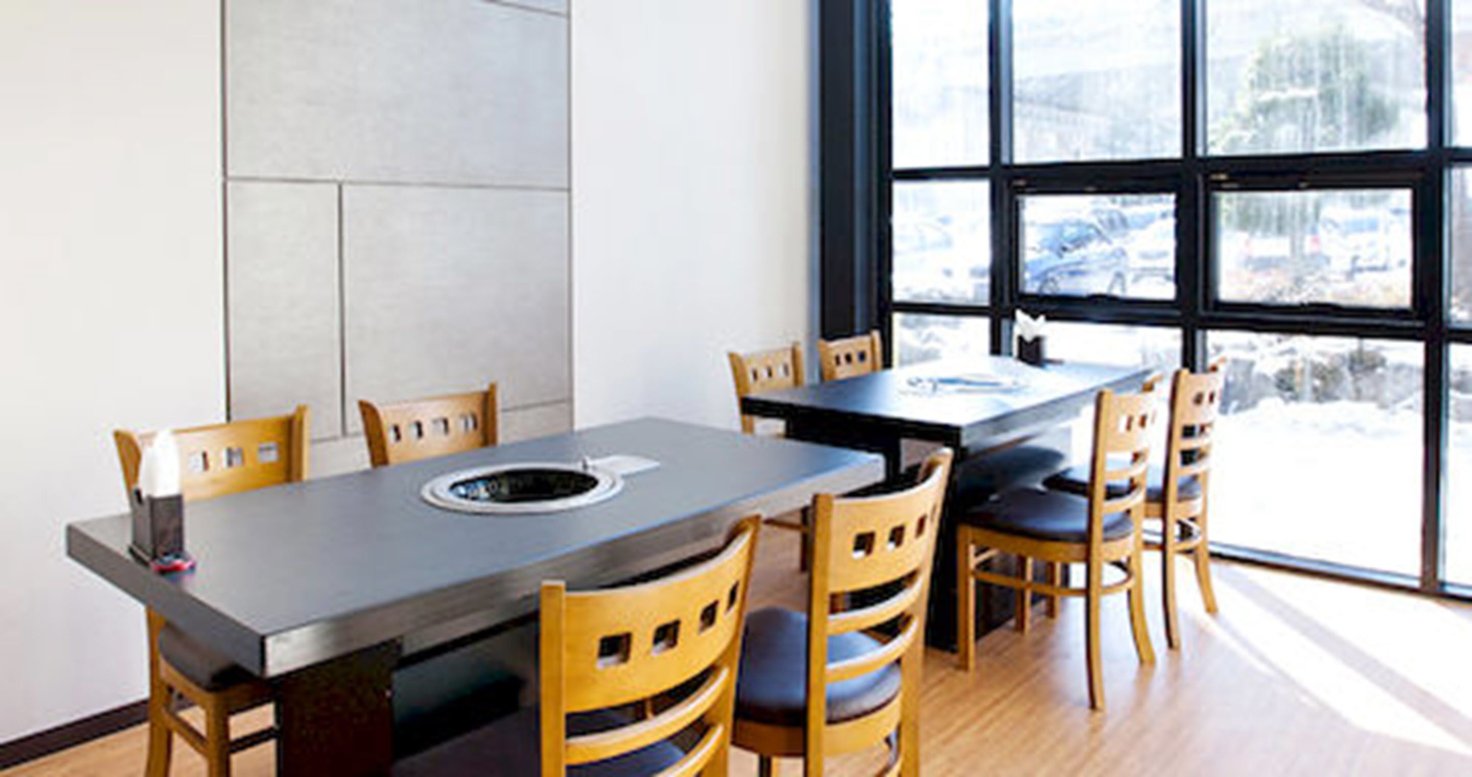 A dining area with a rectangular table and six wooden chairs.