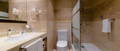 A modern bathroom with a sink, toilet, and glass-enclosed shower.