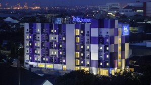 A multi-story hotel with a modern design, featuring a prominent 'ibis budget' sign. - Ibis Budget Semarang Tendean (Semarang)