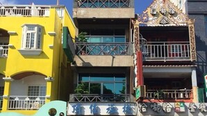 A multi-story building with a ground-level shop and a restaurant on the second floor.
