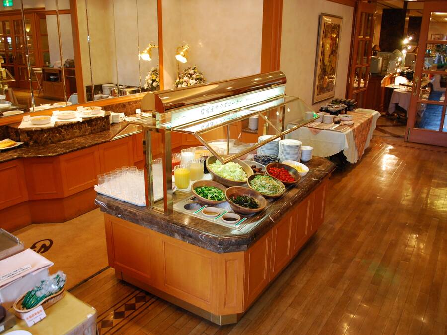 A buffet area with various food items and a glass display case.