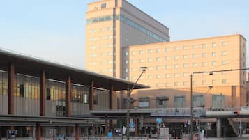 A modern building with a flat roof and large windows, likely a hotel or office building.