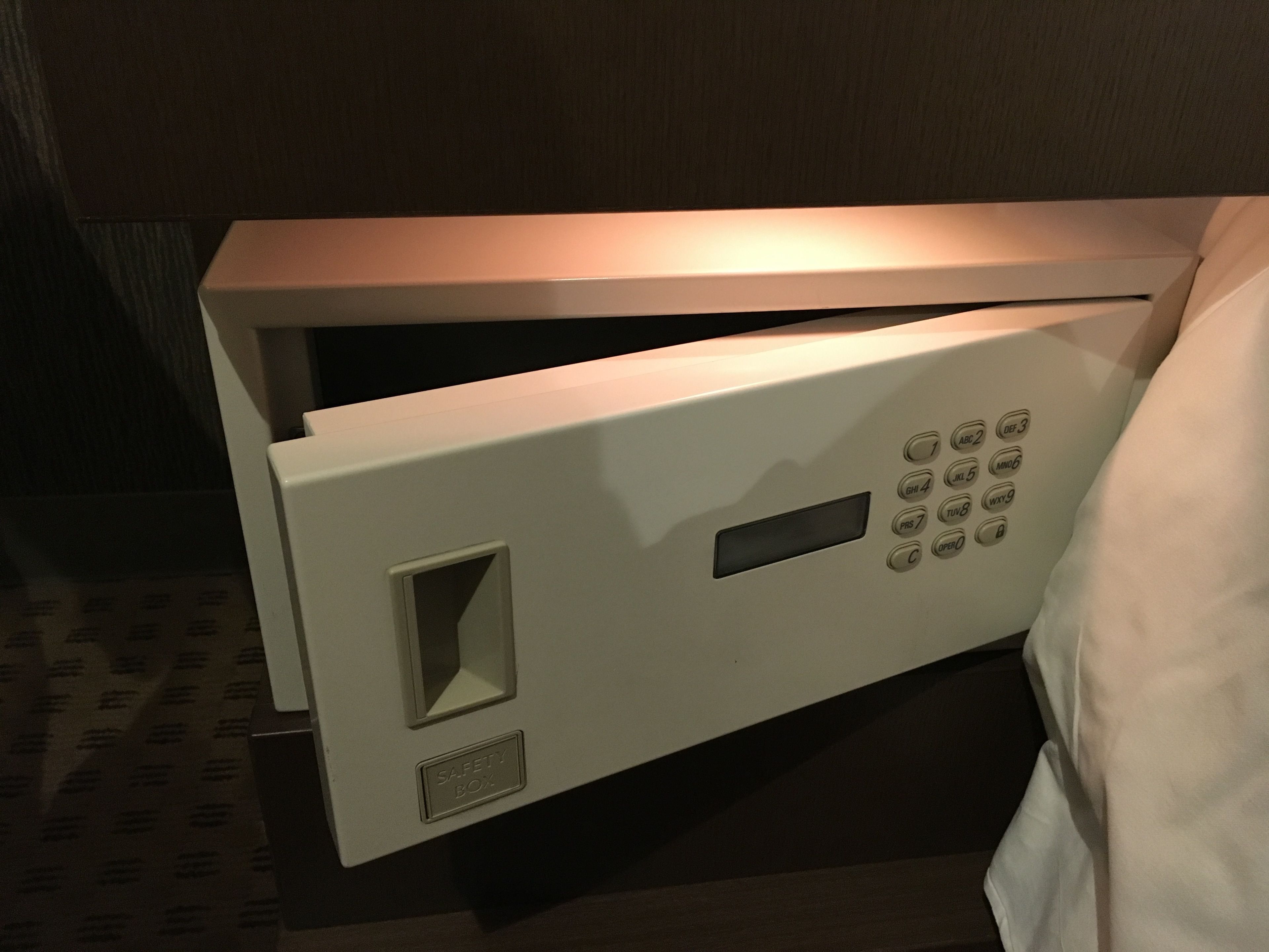 A microwave with a safety box and a control panel with various buttons.