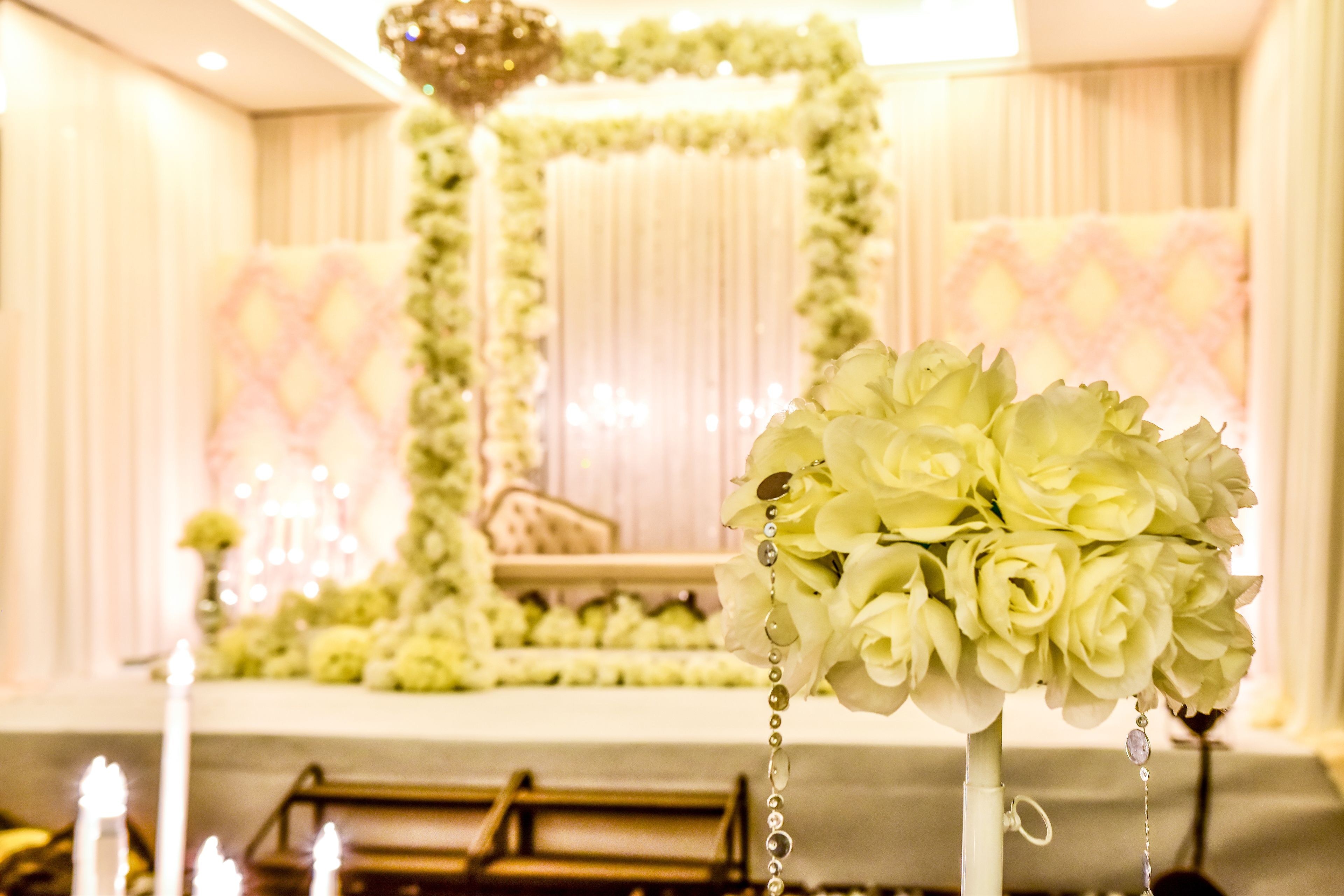 A wedding ceremony setup with floral decorations and candles.