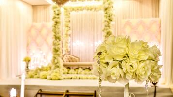 A wedding ceremony setup with floral decorations and candles.