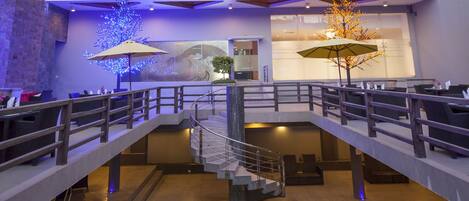 A multi-story hotel with balconies, a swimming pool, and outdoor seating.