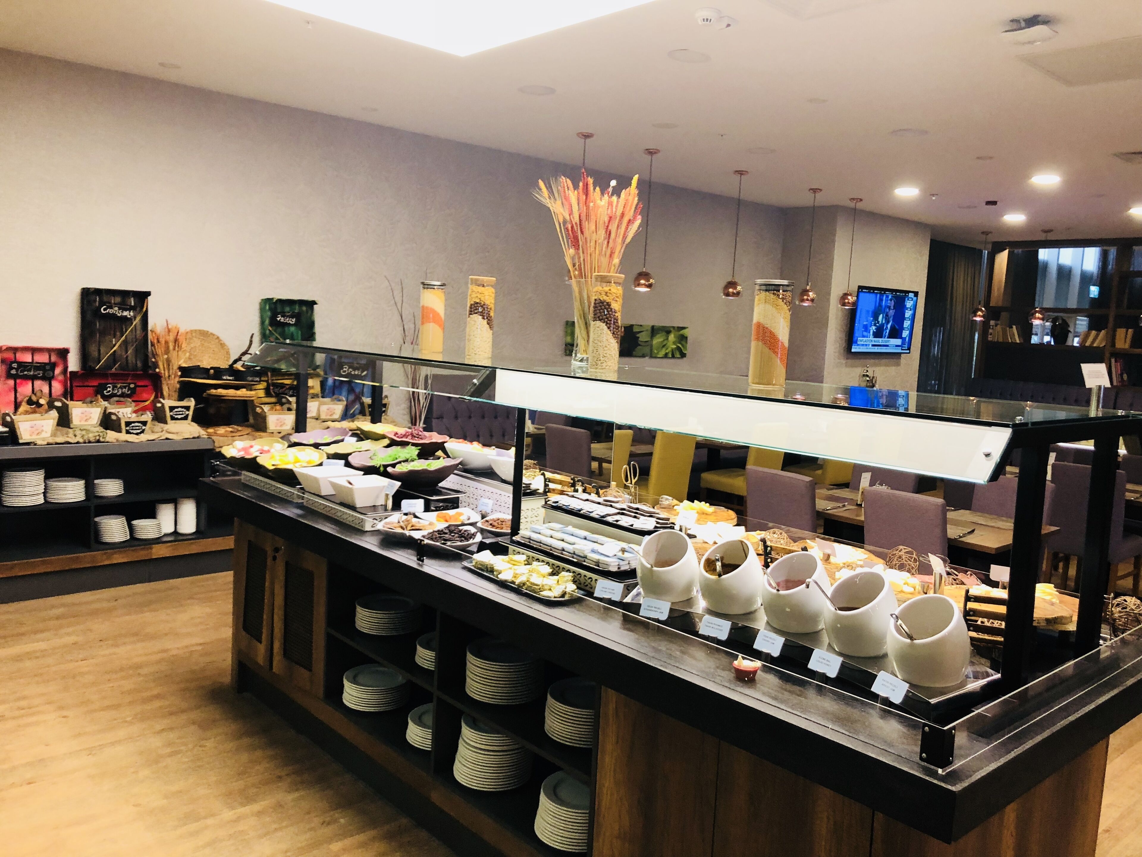 A buffet area with various food items and a glass display case.