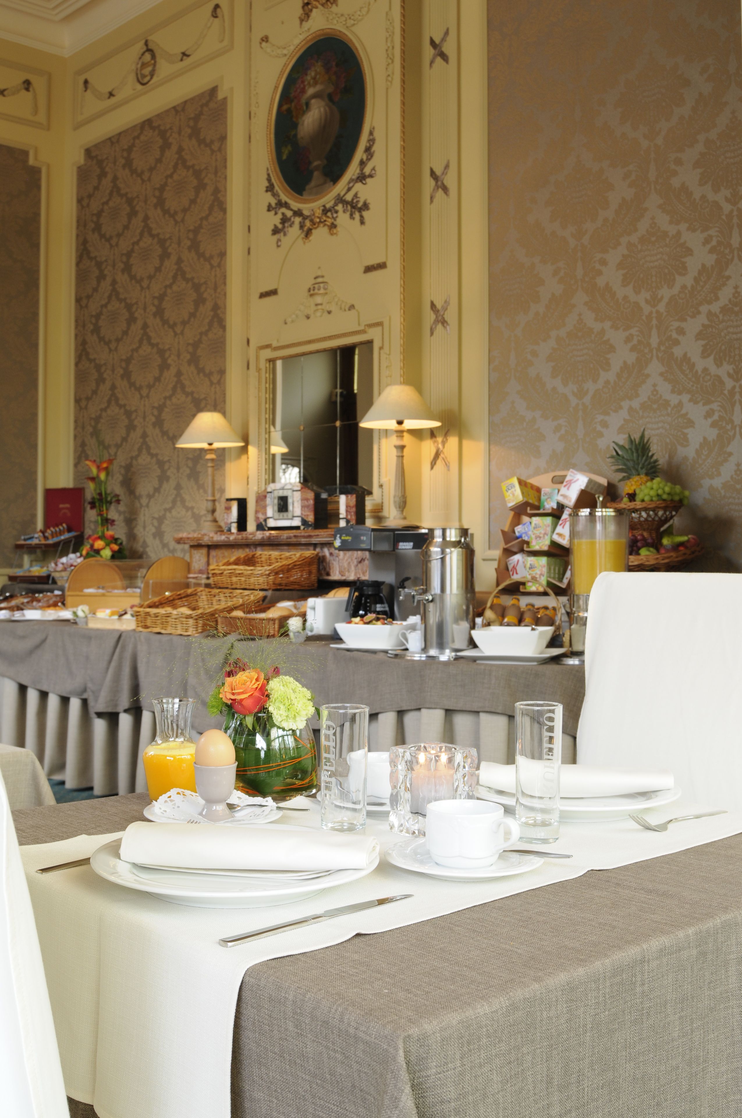 A breakfast buffet setup with various food items and a coffee station.