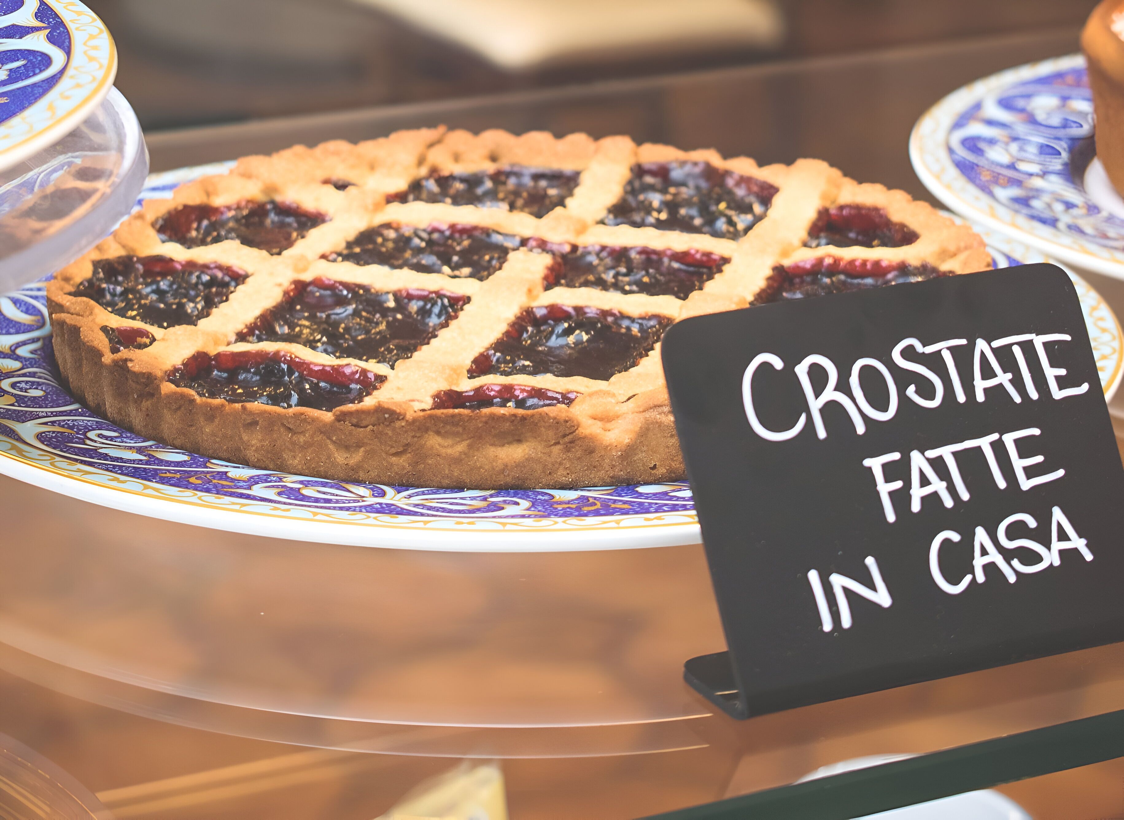 A pie with a lattice crust on a decorative plate.