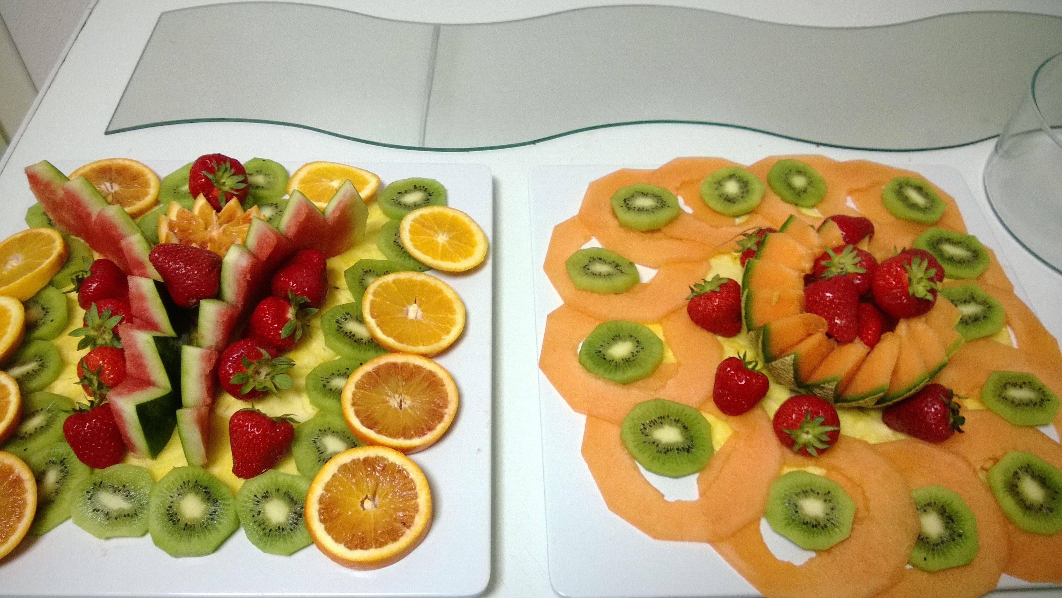 Two fruit platters on white plates.