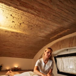 Experience a tranquil massage in this serene space, featuring a massage table and soothing ambiance.