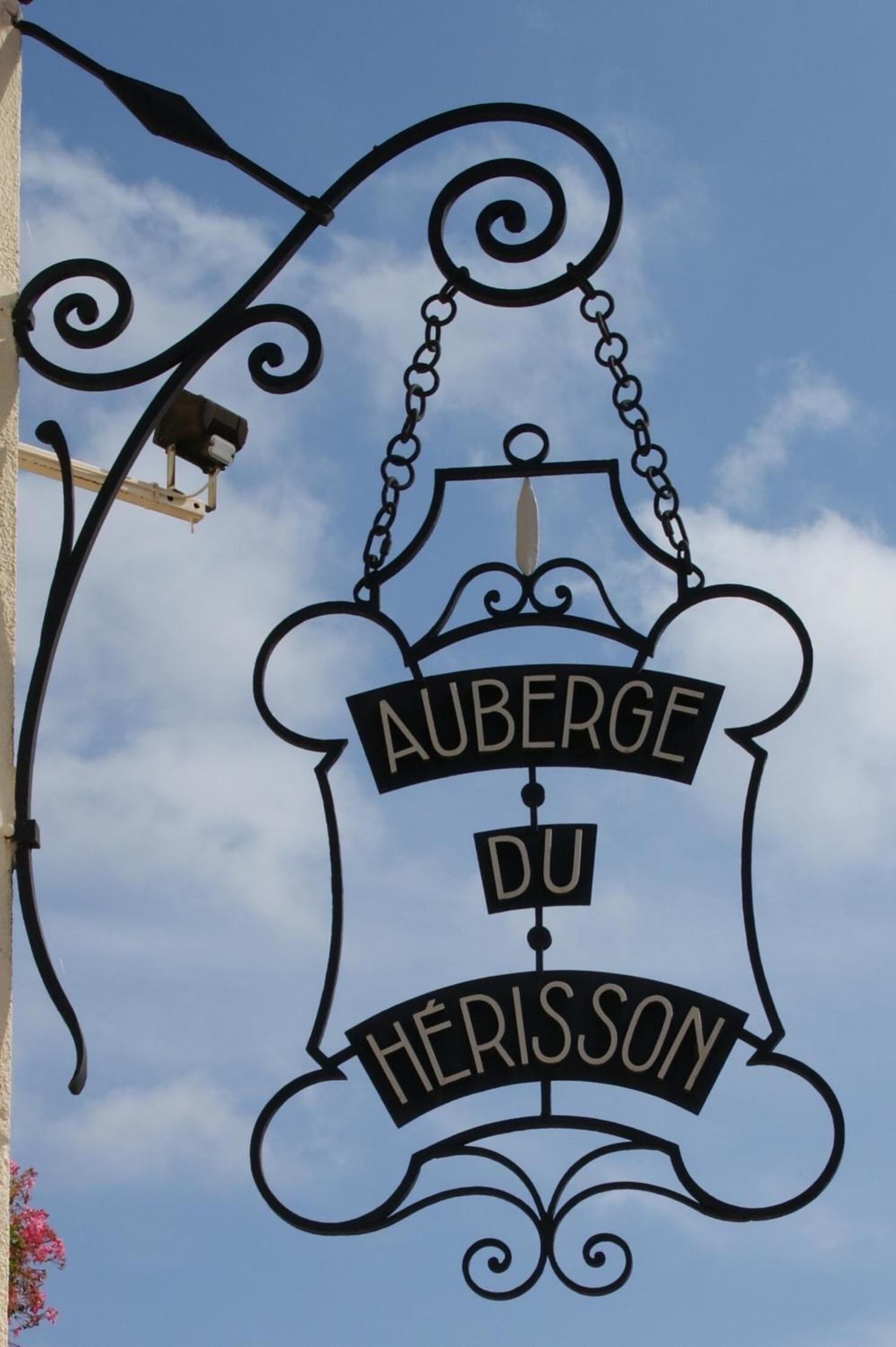 A sign with the text 'AUBERGE DU HERISSON' indicating a hotel or establishment.