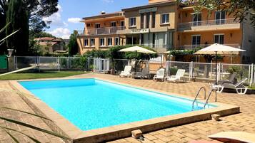 Outdoor pool, open noon to 9:00 PM, pool umbrellas