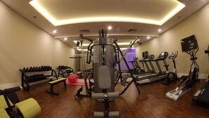 A gym with cardio machines, weightlifting equipment, and a bench. - Luxor Garden Hotel (Izmit)