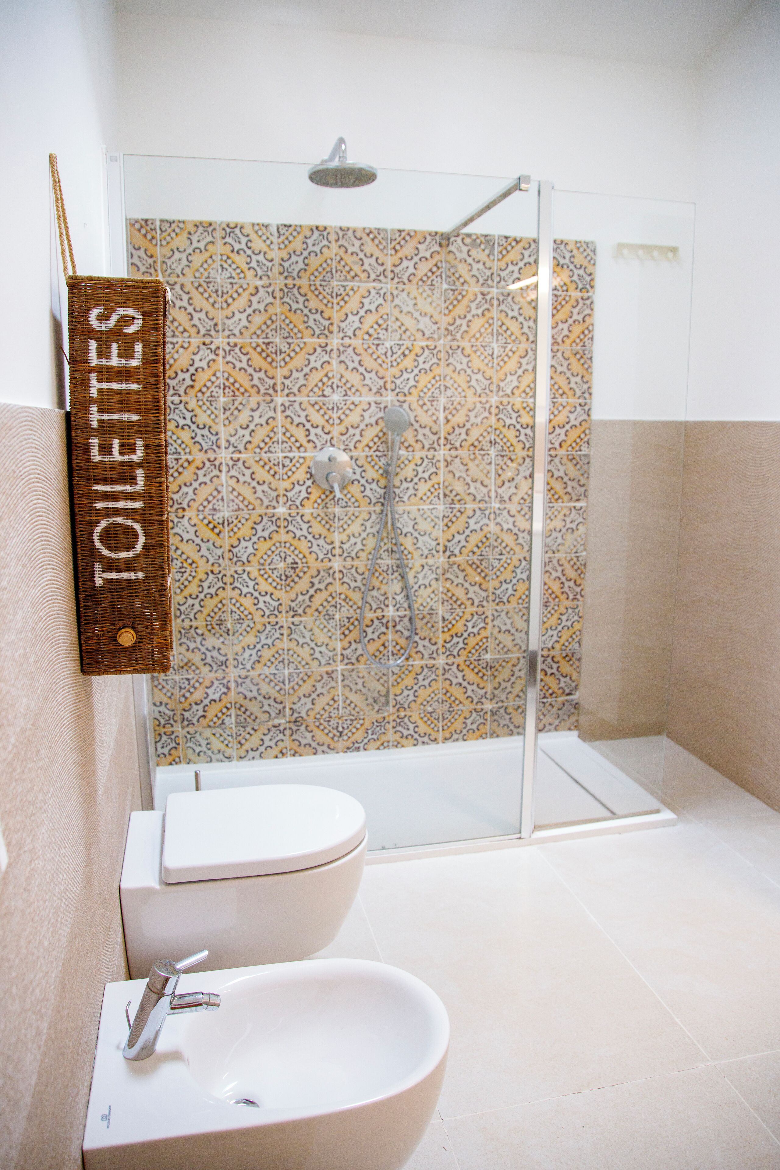A bathroom with a shower, toilet, and sink.
