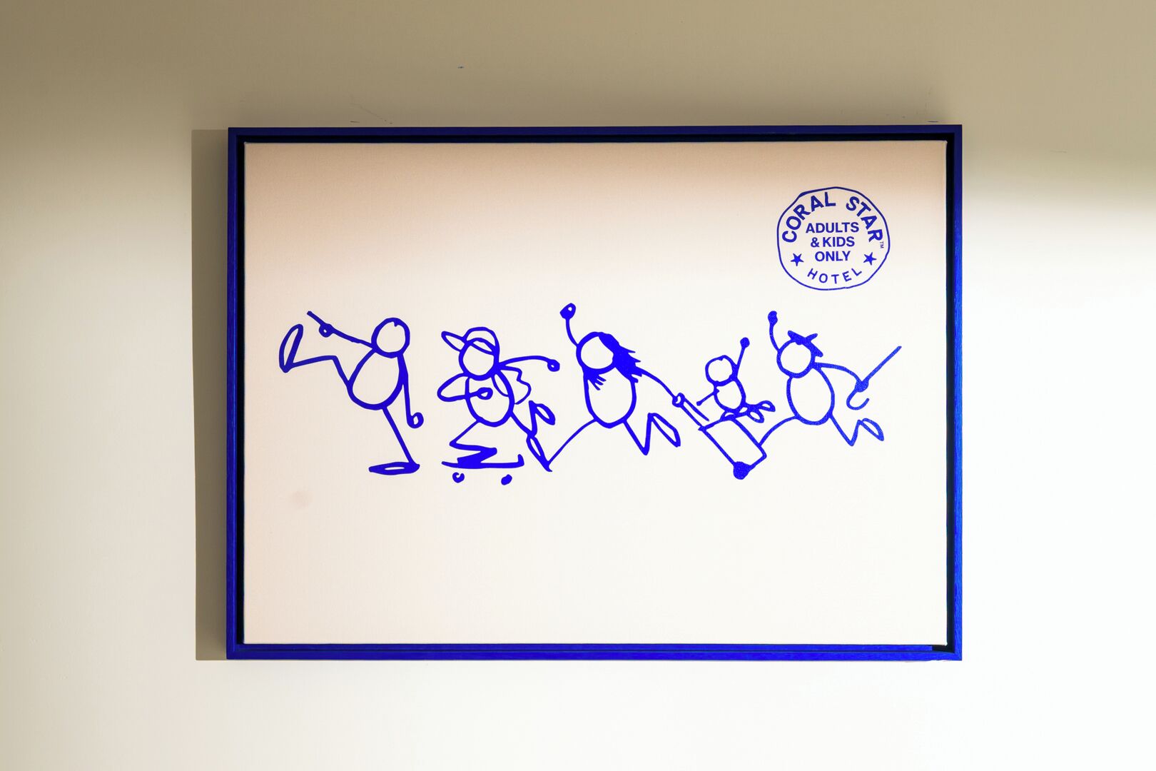A framed drawing of five stylized figures in blue, with a hotel logo and name in the top right corner.