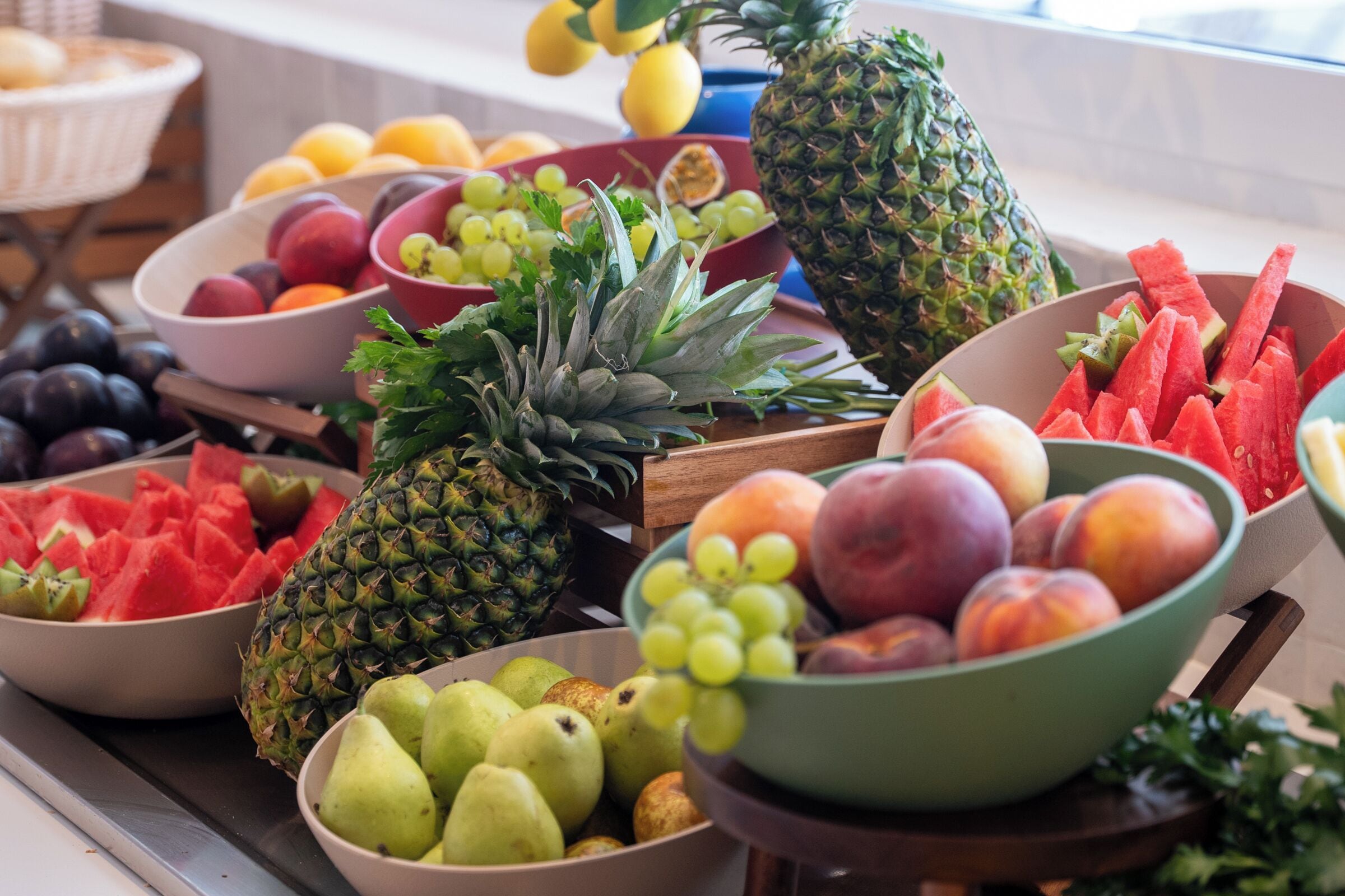 A variety of fresh fruits and vegetables displayed on a wooden table.