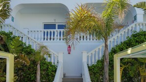 A white building with a staircase, surrounded by greenery and a fire hydrant. - ENDLSS BEACH & DISCO HOTEL IBIZA ADULTS ONLY (Sant Josep de sa Talaia)