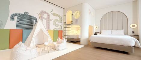 A modern bedroom with a bunk bed, a tent-like play area, and a large bed with a headboard.