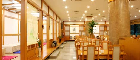 A traditional Japanese-style restaurant with wooden furniture, tatami mats, and shoji screens.