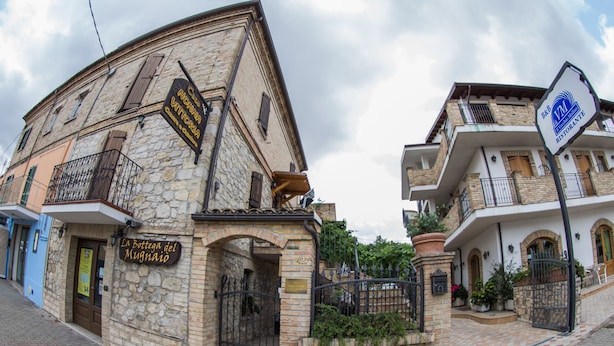 A stone building with a sign for "La Bottega del Mugnaio." - Il Vecchio Mulino (Chieti)