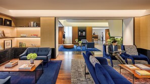 A modern hotel lobby with a reception desk, seating areas, and a large mirror reflecting the space. - Mandarin Oriental, Milan (Milan)