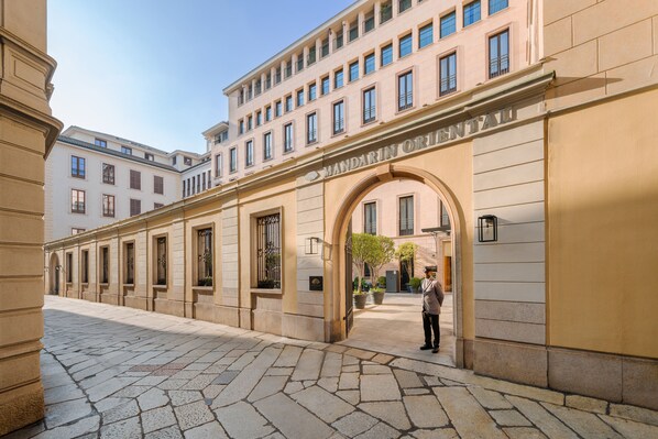 A building with a large arched entrance and a sign reading "MANDARIN ORIENTALI".