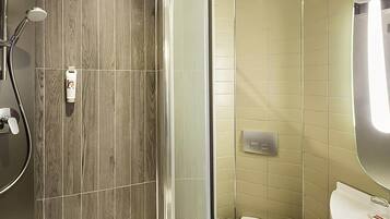 A bathroom with a shower, toilet, and sink.
