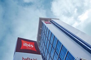 A tall hotel building with a prominent 'ibis Hotels' sign at the top. - Ibis Konya (Konya)