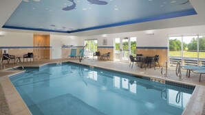 An indoor swimming pool with a ceiling mural of dolphins, a sunroof, and a patio area with chairs and tables. - TownePlace Suites by Marriott Wareham Buzzards Bay (Wareham)