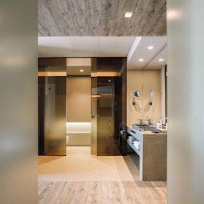 A modern hotel lobby with a wooden ceiling, a reception desk, and a glass partition.