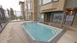 Piscina rectangular con bordeado de azulejos, rodeada por una plataforma de hormigón.