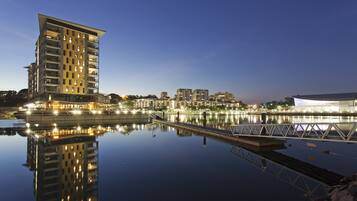 Overlooking a serene body of water, this high-rise building offers stunning views of the city.