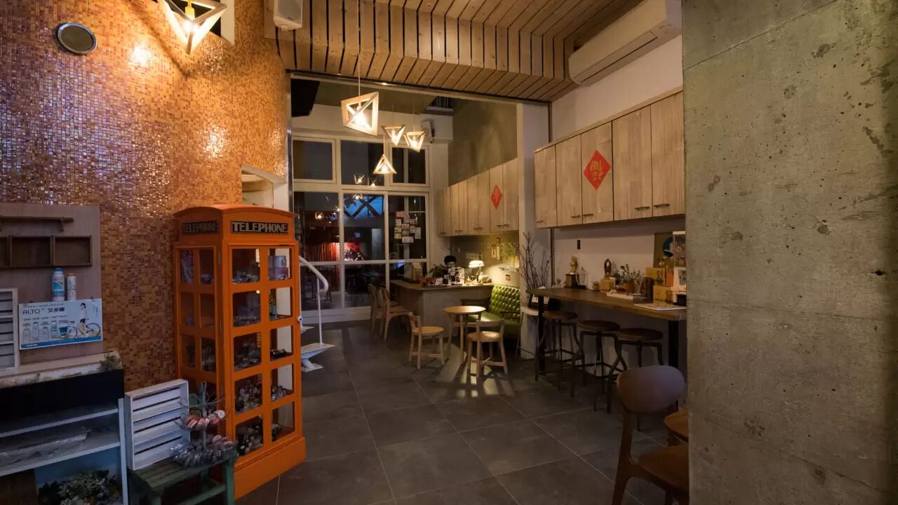 A cozy interior with a telephone booth, wooden cabinets, and a bar area.